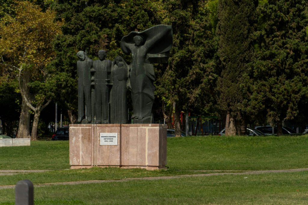 a statue of a group of people in a park